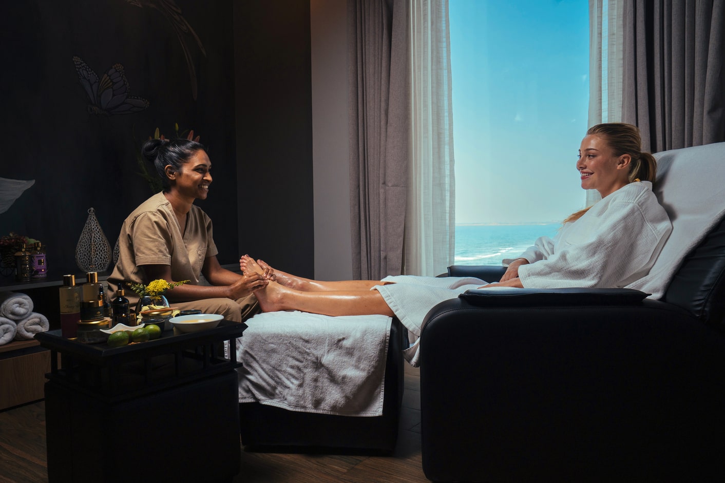 A masseuse performing a head massage on a client in a serene spa in Colombo. The background shows a tastefully decorated room with candles and spa products, reflecting a tranquil and luxurious wellness atmosphere.
